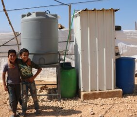 Children in front of a water tank